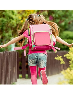 Girl running with pink and green ergonomic school bag featuring a cactus charm