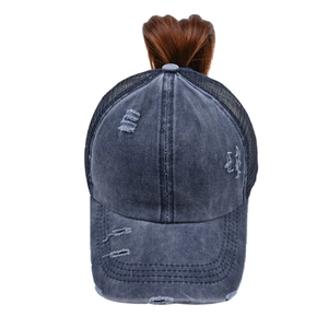 Detail of distressed ponytail baseball cap with crisscross opening and breathable mesh back