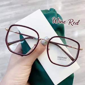 Detail of wine red anti-blue light glasses with gold metal temples and UV400 protection