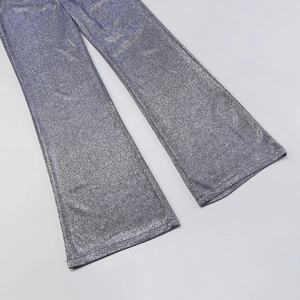 Close-up of glittery silver-purple flared trousers with shimmering sequin fabric texture