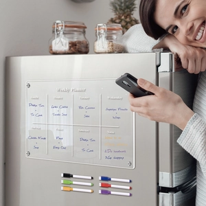 Magnetic acrylic weekly planner on fridge with six colorful dry erase markers