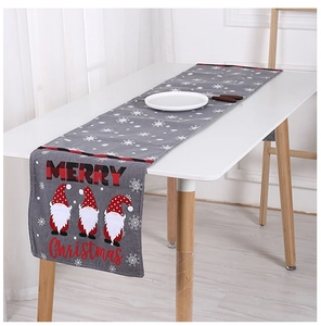 Detail of Christmas table runner with grey knit fabric and festive gnome snowflake patterns