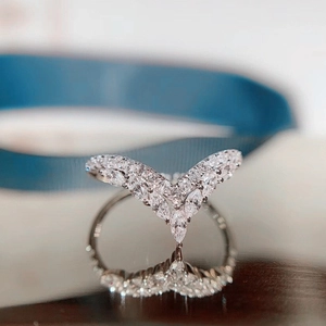 Elegant silver V-shaped ring with marquise-cut white stones and smooth reflection