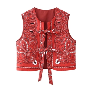 Detail view of red paisley print vest featuring double front bow tie-up straps design