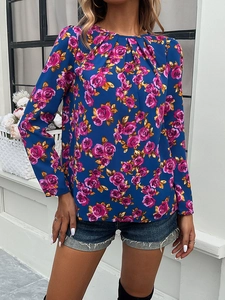 Detail of round neck pleated front blouse featuring pink rose print on blue fabric