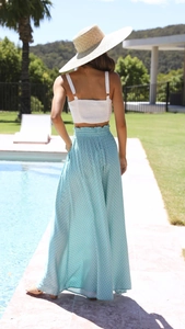 Close-up of white smocked tube top and light blue floral high-waist wide-leg pants set