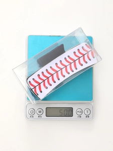 Detailed weight display of baseball patterned hair claw clip in clear retail packaging