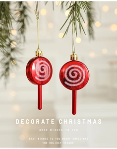 Close-up of red and silver glitter spiral lollipop ornaments with golden string for Christmas