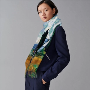 Detail of Van Gogh Wheat Field print scarf with green tassels on navy suit