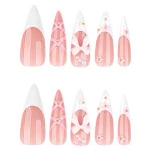 Pink and white French press-on nails with 3D bows, pearls, and floral embellishments