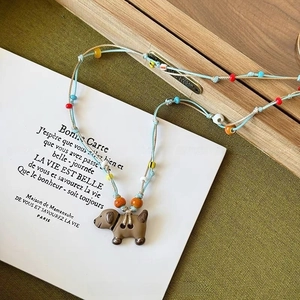 Detail of adjustable 115cm woven necklace with cute dog pendant and colorful beads