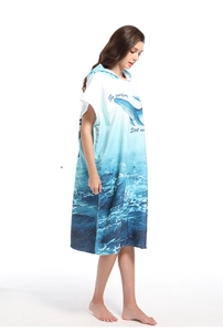 Detail of adult hooded beach towel robe with whale pattern and Go Surfing text