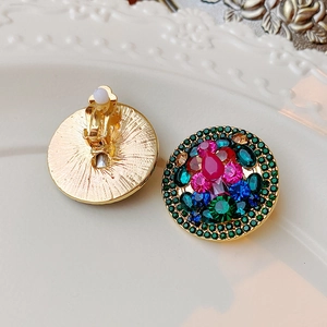 Close-up of vintage gold clip-on earrings with colorful rhinestones and soft anti-slip pads