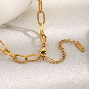 Detailed macro view of 18K gold plated necklace chain with lobster clasp and extender