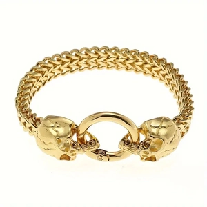 Close-up of golden Viking skull bracelet with franco link chain and circular ring clasp