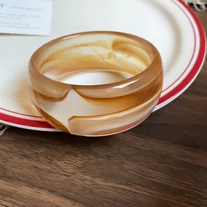 Vintage amber marble acrylic resin bangle with a polished finish and wide grooved design