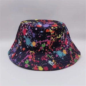 Detail shot of black bucket hat featuring vibrant multicolor paint splatter graffiti pattern