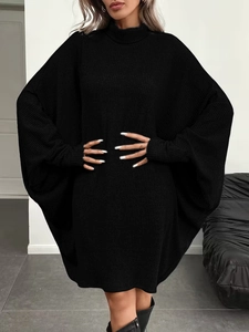 Close-up of black oversized knit sweater dress featuring loose batwing sleeves and high neck