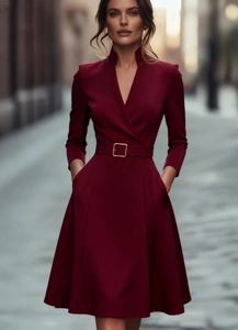 Detailed close-up of wine red long sleeve dress with waist belt and side pockets