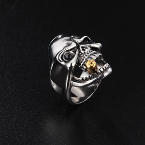 Macro detail of gothic skull ring with golden pipe accent in durable stainless steel