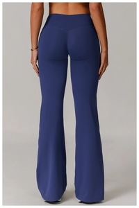 Detailed back view of high-waisted flared yoga pants with V-shaped rear seam in dark blue