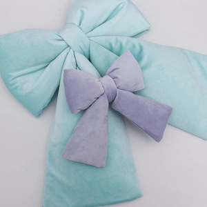 Detailed view of light blue and lavender velvet bows with soft fabric texture
