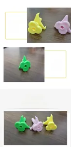 Detail of flower-shaped plastic coconut openers in green, pink, and yellow colors