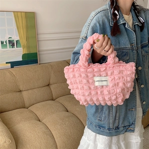 Detailed view of pink bubble texture fabric handbag with Love Sozakka label