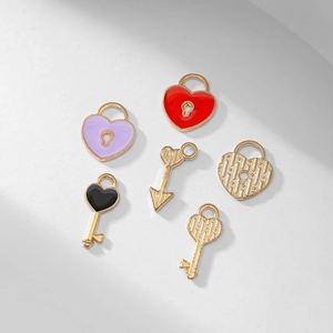 Set of six gold-plated enamel heart lock and key charms on a clean white background