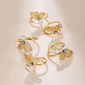Gold-plated butterfly rings set with blue evil eye beads and sparkling cubic zirconia