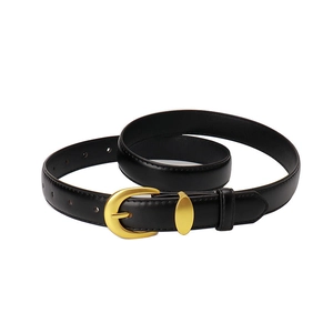Women's black leather belt with a polished gold C-shaped buckle on white background