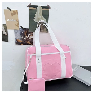 Pink JK uniform bag with heart-shaped clear window and matching coin purse