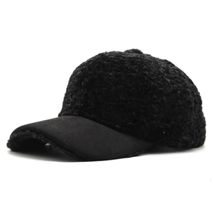 Close-up of black fleece texture and matte brim on a warm winter baseball cap