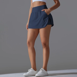 Detail view of high waisted navy tennis skort showing side pockets and elastic fabric texture