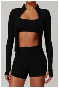 Close-up of black three-piece athletic set featuring zipper jacket and slim fit shorts
