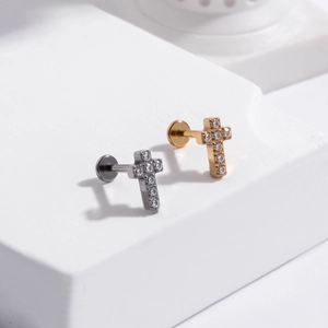 Detail view of G23 titanium cross stud earrings in gold and silver with zircon