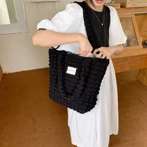 Detail of black cloud bubble texture tote bag featuring white LOVE SOZAKKA woven label