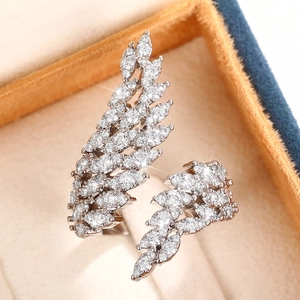 Macro detail of silver feather ring wings set with sparkling cubic zirconia stones