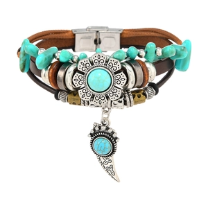 Detail of multi-layer brown leather bracelet with silver flower and turquoise horn charm