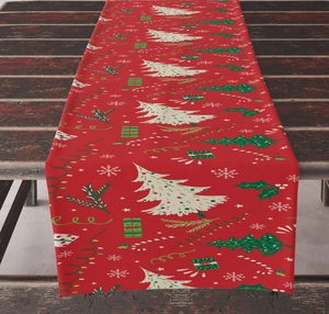 Detailed pattern of a red linen Christmas table runner with white trees and gift boxes