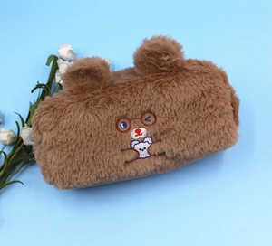 Detail of cute brown plush bear pencil case featuring 3D ears and cartoon embroidery