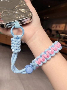 Detail of adjustable blue and pink braided wrist lanyard on silver texture phone case