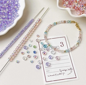 Macro detail of faceted colorful crystal beads and DIY bracelets in soft lighting