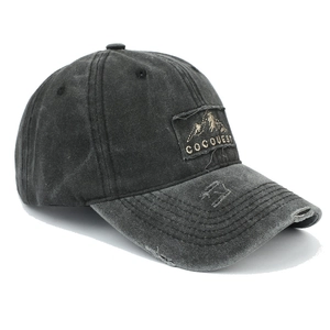 Macro detail of washed cotton baseball cap featuring vintage frayed edges and mountain patch