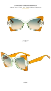 Detail of oversized butterfly sunglasses featuring orange and green tortoiseshell frames