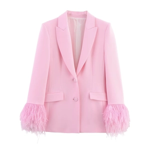 Pink blazer and pants set with lush feather cuffs and a sharp peak lapel design