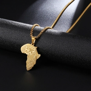 Macro shot of gold stainless steel Africa map pendant with Eye of Horus engraving