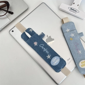 Close-up of denim stylus pencil case with elastic strap for iPad showing star embroidery