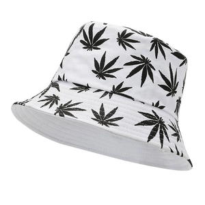 White canvas bucket hat featuring black maple leaf print with a wide brim for sun protection