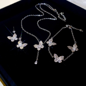 Macro view of silver butterfly jewelry set with sparkling zircons in a black velvet box